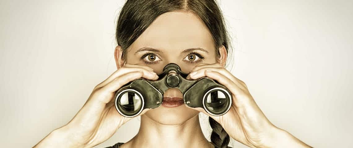 A woman with binoculars looking for negative seo